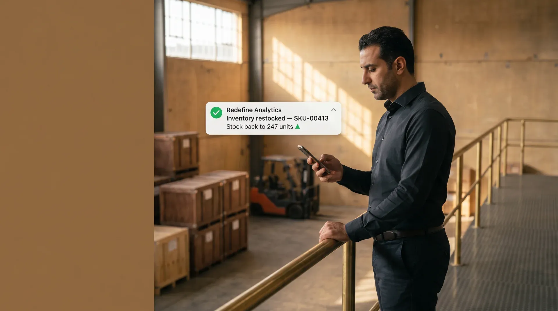 Operations manager checking an automated inventory alert notification on a mobile device Operations manager checking an automated inventory alert notification on a mobile device