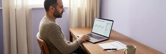 Platform engineer reviewing scoped environment architecture proposal on laptop in focused workspace Platform engineer reviewing scoped environment architecture proposal on laptop in focused workspace
