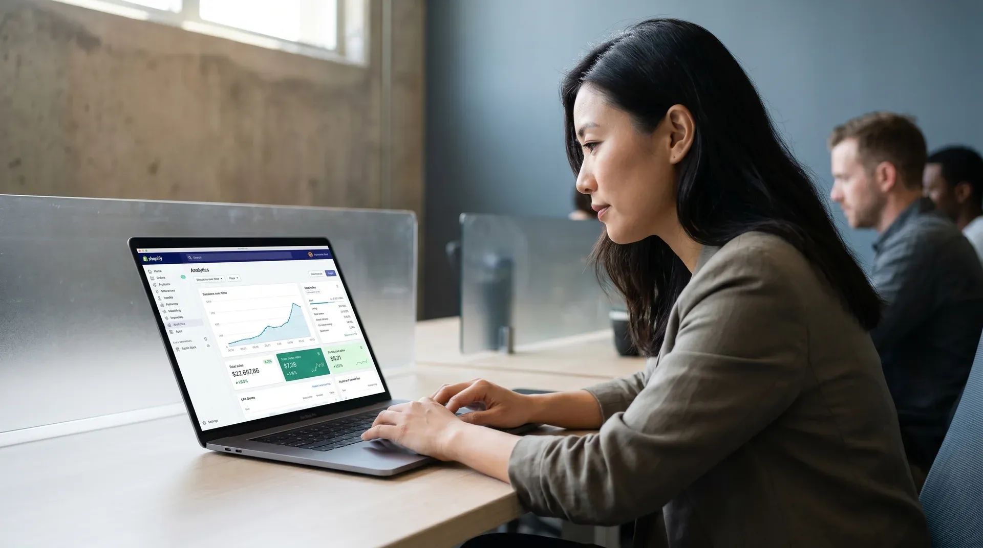 Merchant reviewing a custom Shopify store design on a MacBook Pro, planning next build phase Merchant reviewing a custom Shopify store design on a MacBook Pro, planning next build phase