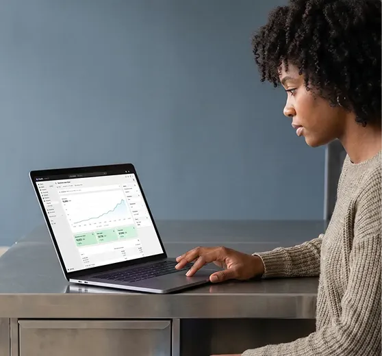 Store owner reviewing strong Shopify theme metrics on laptop Store owner reviewing strong Shopify theme metrics on laptop