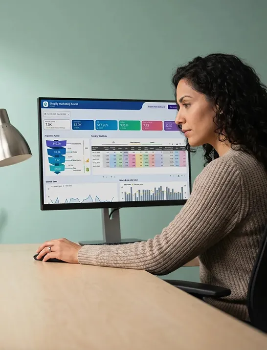 Ecommerce manager calmly reviewing rising conversion rate metrics at a modern office desk Ecommerce manager calmly reviewing rising conversion rate metrics at a modern office desk
