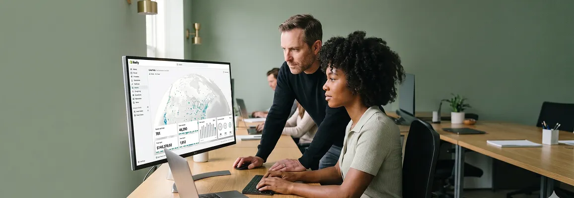 Ecommerce operations team monitoring Shopify store performance dashboards together at screens in well-lit modern office Ecommerce operations team monitoring Shopify store performance dashboards together at screens in well-lit modern office