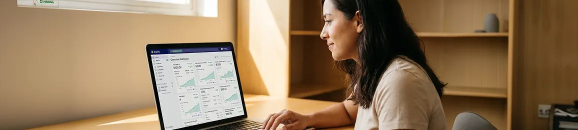 Ecommerce founder calmly reviewing a healthy, proactively maintained Shopify Admin dashboard with green metrics in a bright office Ecommerce founder calmly reviewing a healthy, proactively maintained Shopify Admin dashboard with green metrics in a bright office