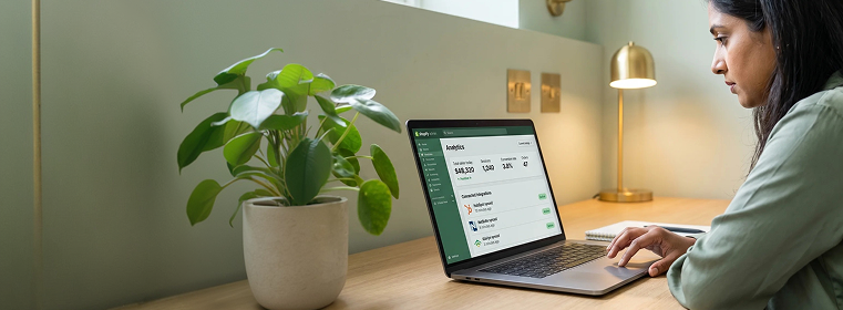 Ecommerce manager reviewing live Shopify integration status dashboard Ecommerce manager reviewing live Shopify integration status dashboard